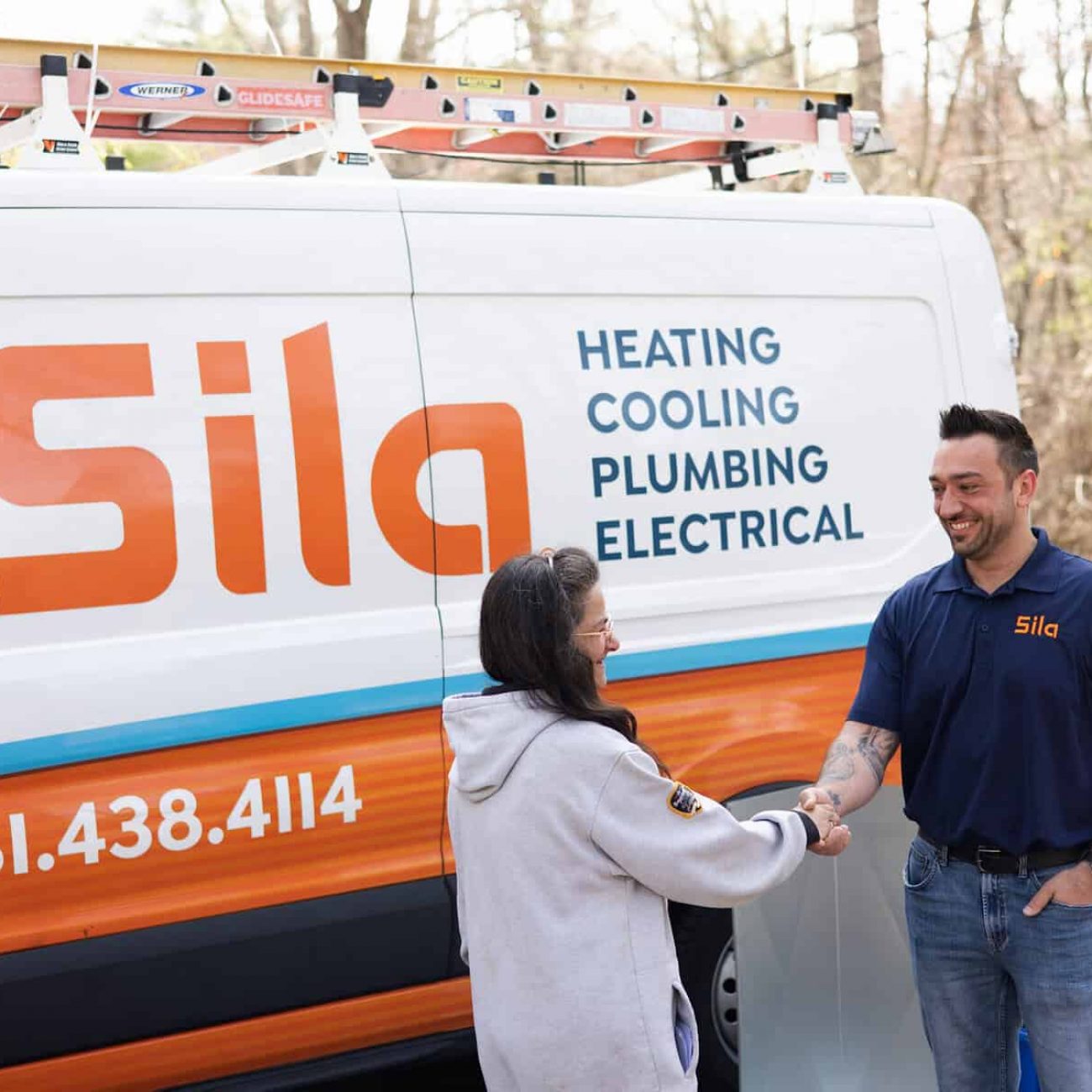 A Sila technician shakes hands with a customer outside next to a Sila service van offering heating, cooling, plumbing, and electrical services.
